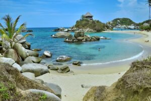 a beach with rocks and a small island