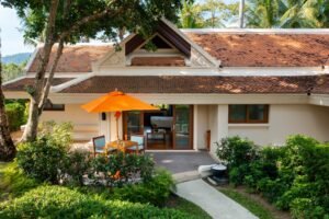 a house with a patio and a table:Island Bliss